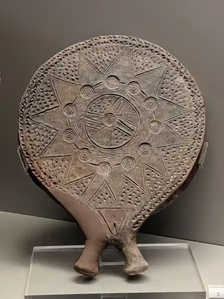 Early Cycladic ceramic frying pan featuring central sun wheel surrounded by radiating star pattern and geometric borders from Syros